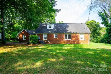 Discover this charming brick home in Revolution Park, minutes on Carolina Golf Club in North Carolina - for sale on GolfHomes.com, golf home, golf lot