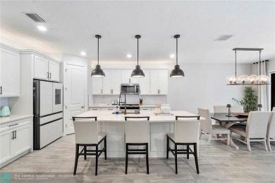 Beautifully upgraded pool home on the golf course. Boasting 4 on Woodmont Country Club in Florida - for sale on GolfHomes.com, golf home, golf lot