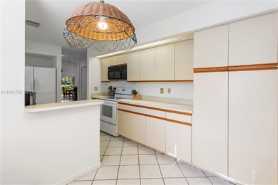 This spacious well maintained 3-bedroom, 2.5-bath townhome with on Woodmont Country Club in Florida - for sale on GolfHomes.com, golf home, golf lot