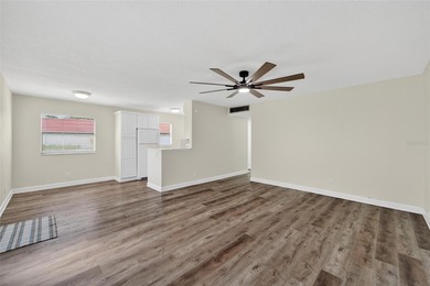 This bright condo features a living room-dining room combination on Sandpiper Golf Club in Florida - for sale on GolfHomes.com, golf home, golf lot