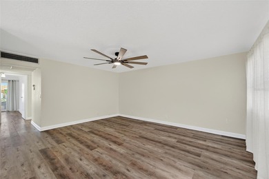 This bright condo features a living room-dining room combination on Sandpiper Golf Club in Florida - for sale on GolfHomes.com, golf home, golf lot