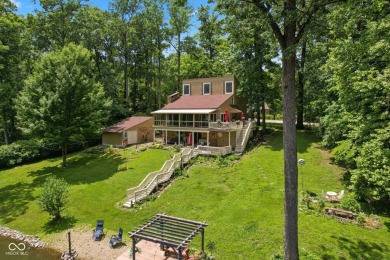 Nestled on the tranquil shores of a private lake, this elegant on Foxcliff Golf Club in Indiana - for sale on GolfHomes.com, golf home, golf lot