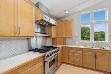 FRESH AND SLEEK CONDOMINIUM combining clean lines with practical on Elks Lodge 590 in Iowa - for sale on GolfHomes.com, golf home, golf lot