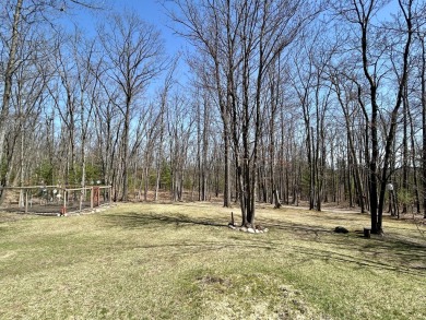 Privacy and seclusion await at this true Up North retreat! This on Forest Dunes Golf Club in Michigan - for sale on GolfHomes.com, golf home, golf lot
