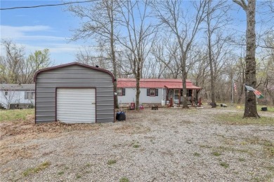 Enjoy your summer at the lake with this charming cabin located on Sugar Valley Lakes Golf Course in Kansas - for sale on GolfHomes.com, golf home, golf lot