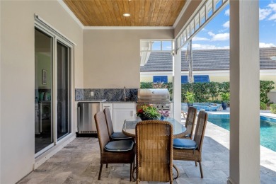 This stunning courtyard pool home with serene lake views has on Orchid Island Golf and Beach Club in Florida - for sale on GolfHomes.com, golf home, golf lot