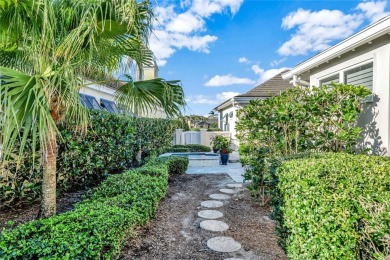 This stunning courtyard pool home with serene lake views has on Orchid Island Golf and Beach Club in Florida - for sale on GolfHomes.com, golf home, golf lot