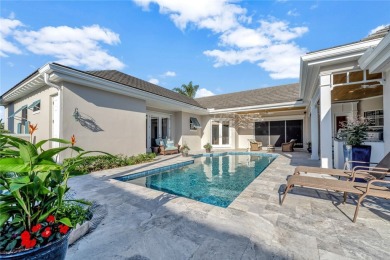 This stunning courtyard pool home with serene lake views has on Orchid Island Golf and Beach Club in Florida - for sale on GolfHomes.com, golf home, golf lot