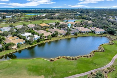 This stunning courtyard pool home with serene lake views has on Orchid Island Golf and Beach Club in Florida - for sale on GolfHomes.com, golf home, golf lot