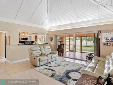 Natural light welcomes you as it fills the large, open living on Woodlands Country Club in Florida - for sale on GolfHomes.com, golf home, golf lot