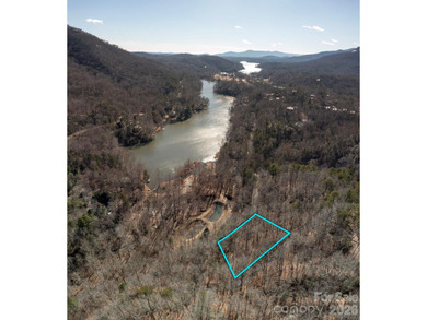 Come see this pretty, sloping lot with distant lake views on Rumbling Bald Resort on Lake Lure in North Carolina - for sale on GolfHomes.com, golf home, golf lot