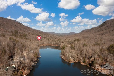 Come see this pretty, sloping lot with distant lake views on Rumbling Bald Resort on Lake Lure in North Carolina - for sale on GolfHomes.com, golf home, golf lot