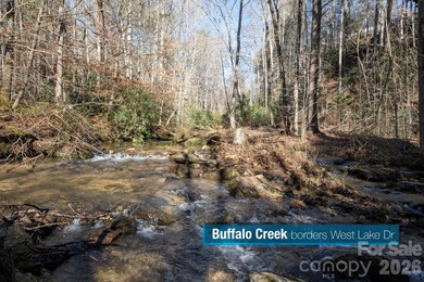 Come see this pretty, sloping lot with distant lake views on Rumbling Bald Resort on Lake Lure in North Carolina - for sale on GolfHomes.com, golf home, golf lot
