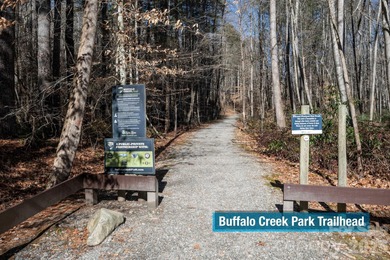 Come see this pretty, sloping lot with distant lake views on Rumbling Bald Resort on Lake Lure in North Carolina - for sale on GolfHomes.com, golf home, golf lot
