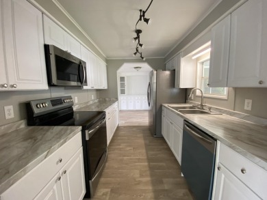 Lovely remodeled home with new kitchen, flooring, roof and on Spanish Lakes Golf Village in Florida - for sale on GolfHomes.com, golf home, golf lot