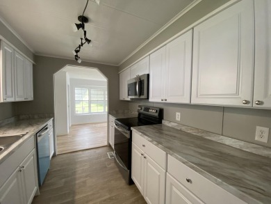 Lovely remodeled home with new kitchen, flooring, roof and on Spanish Lakes Golf Village in Florida - for sale on GolfHomes.com, golf home, golf lot