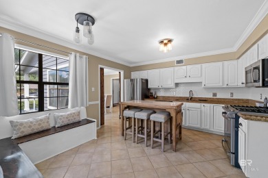 Located in Wedgewood Estates, this Gulf Shores retreat with a on The Golf Club of the Wharf in Alabama - for sale on GolfHomes.com, golf home, golf lot