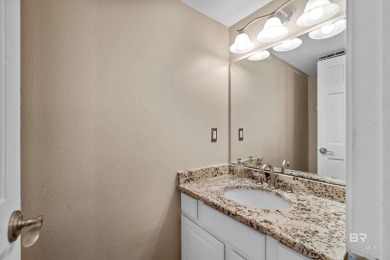 Located in Wedgewood Estates, this Gulf Shores retreat with a on The Golf Club of the Wharf in Alabama - for sale on GolfHomes.com, golf home, golf lot
