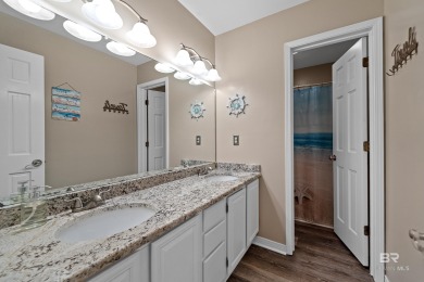 Located in Wedgewood Estates, this Gulf Shores retreat with a on The Golf Club of the Wharf in Alabama - for sale on GolfHomes.com, golf home, golf lot