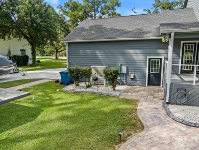 Located in Wedgewood Estates, this Gulf Shores retreat with a on The Golf Club of the Wharf in Alabama - for sale on GolfHomes.com, golf home, golf lot