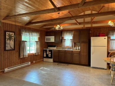 This is a must-see cozy cottage, located in Canadian Lakes with on Canadian Lakes Country Club-The Pines Course in Michigan - for sale on GolfHomes.com, golf home, golf lot