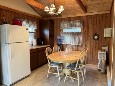 This is a must-see cozy cottage, located in Canadian Lakes with on Canadian Lakes Country Club-The Pines Course in Michigan - for sale on GolfHomes.com, golf home, golf lot