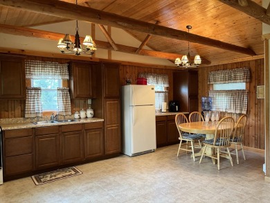 This is a must-see cozy cottage, located in Canadian Lakes with on Canadian Lakes Country Club-The Pines Course in Michigan - for sale on GolfHomes.com, golf home, golf lot