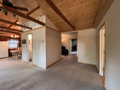 This is a must-see cozy cottage, located in Canadian Lakes with on Canadian Lakes Country Club-The Pines Course in Michigan - for sale on GolfHomes.com, golf home, golf lot