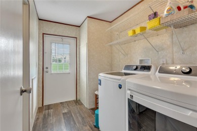 This practically NEW 2021 Built 3/2 Split plan home is located on Zellwood Station Country Club in Florida - for sale on GolfHomes.com, golf home, golf lot