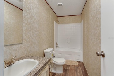 This practically NEW 2021 Built 3/2 Split plan home is located on Zellwood Station Country Club in Florida - for sale on GolfHomes.com, golf home, golf lot