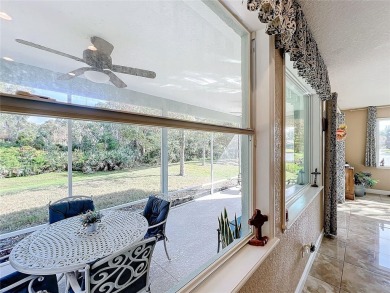 This light-filled home boasts beautiful views from the side of on Tuscawilla Country Club in Florida - for sale on GolfHomes.com, golf home, golf lot