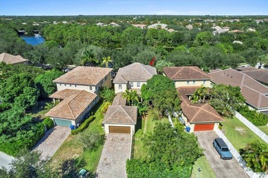 Versatile 4-bedroom, 3-bath Abacoa residence with sparkling LAKE on The Club At Admirals Cove Golf Village in Florida - for sale on GolfHomes.com, golf home, golf lot
