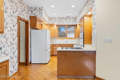 This unique, custom-built home rests on nearly  3/4  of an acre on Lockwood Folly Country Club in North Carolina - for sale on GolfHomes.com, golf home, golf lot
