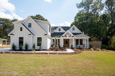 Welcome to your ideal coastal retreat! This beautiful 1.5 story on Crow Creek Golf Club in North Carolina - for sale on GolfHomes.com, golf home, golf lot