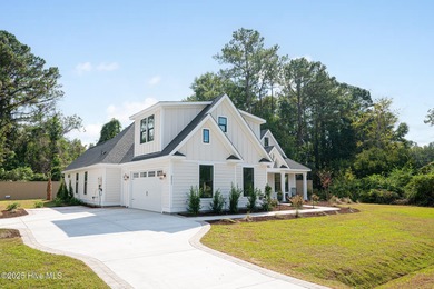 Welcome to your ideal coastal retreat! This beautiful 1.5 story on Crow Creek Golf Club in North Carolina - for sale on GolfHomes.com, golf home, golf lot