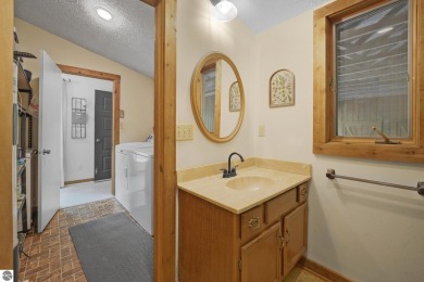 Anchor your Northern Michigan adventures at this architecturally on The Chief Golf Course in Michigan - for sale on GolfHomes.com, golf home, golf lot