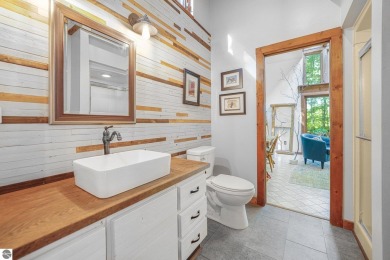 Anchor your Northern Michigan adventures at this architecturally on The Chief Golf Course in Michigan - for sale on GolfHomes.com, golf home, golf lot