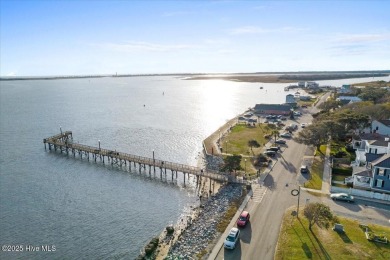 Experience the pleasures of coastal living in this charming on South Harbour Golf Links in North Carolina - for sale on GolfHomes.com, golf home, golf lot