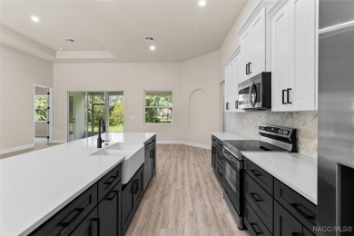 This home offers modern elegance and the tranquility of golf on Southern Woods Golf Club in Florida - for sale on GolfHomes.com, golf home, golf lot