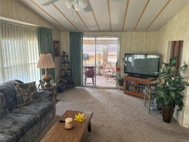 Spacious 2-bedroom, 2-bath home on a large corner lot with over on Zellwood Station Country Club in Florida - for sale on GolfHomes.com, golf home, golf lot