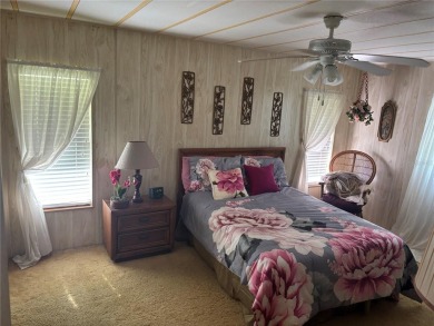 Spacious 2-bedroom, 2-bath home on a large corner lot with over on Zellwood Station Country Club in Florida - for sale on GolfHomes.com, golf home, golf lot