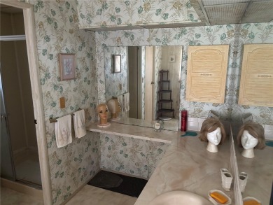 Spacious 2-bedroom, 2-bath home on a large corner lot with over on Zellwood Station Country Club in Florida - for sale on GolfHomes.com, golf home, golf lot