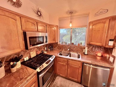 Floor to ceiling windows capture the relaxing golf course views on Yuma Golf and Country Club in Arizona - for sale on GolfHomes.com, golf home, golf lot