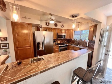 Floor to ceiling windows capture the relaxing golf course views on Yuma Golf and Country Club in Arizona - for sale on GolfHomes.com, golf home, golf lot