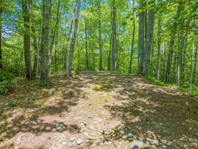 Set on a gentle knoll above Lake Toxaway, this prime lot on Lake Toxaway Country Club in North Carolina - for sale on GolfHomes.com, golf home, golf lot