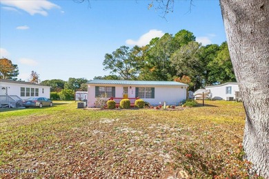 Come home to your beach getaway. This two bedroom, two flex on Oyster Bay Golf Links in North Carolina - for sale on GolfHomes.com, golf home, golf lot