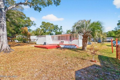 Come home to your beach getaway. This two bedroom, two flex on Oyster Bay Golf Links in North Carolina - for sale on GolfHomes.com, golf home, golf lot