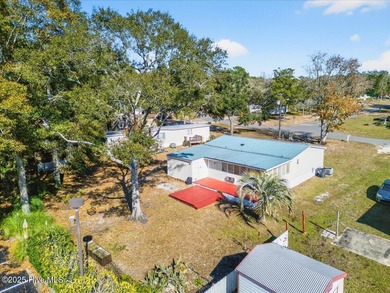 Come home to your beach getaway. This two bedroom, two flex on Oyster Bay Golf Links in North Carolina - for sale on GolfHomes.com, golf home, golf lot