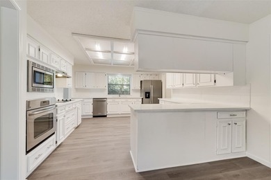 Tucked beneath mature trees in one of Rockwall's most on The Shores Country Club in Texas - for sale on GolfHomes.com, golf home, golf lot