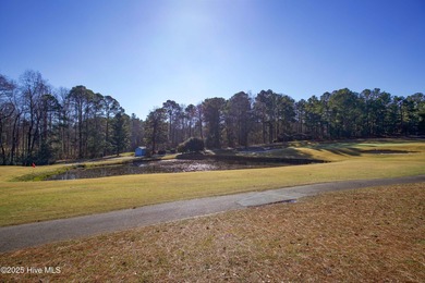 Perfectly positioned on a dog-leg right par five of the Seven on Seven Lakes Country Club in North Carolina - for sale on GolfHomes.com, golf home, golf lot